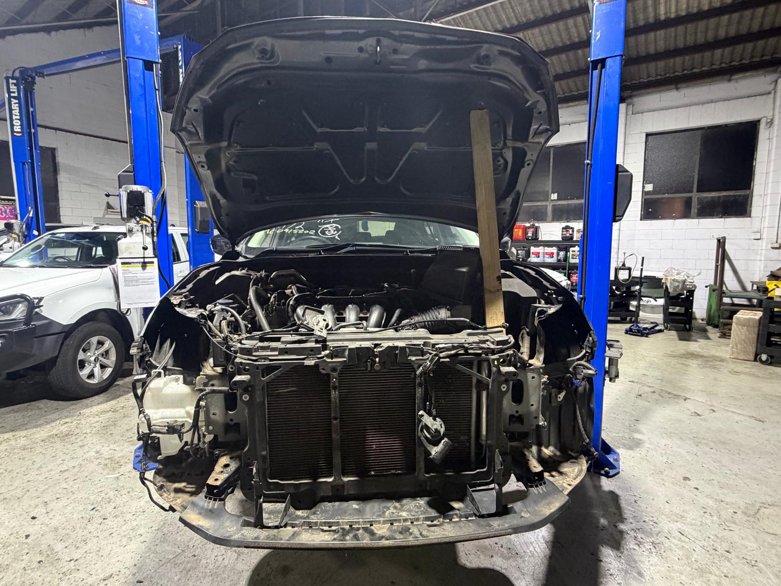 Car on a hoist inside the Kochhar Motors workshop
